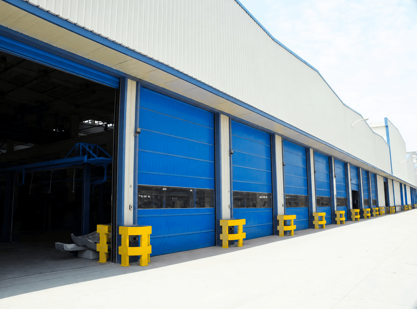 Stacking doors installed along a factory exterior